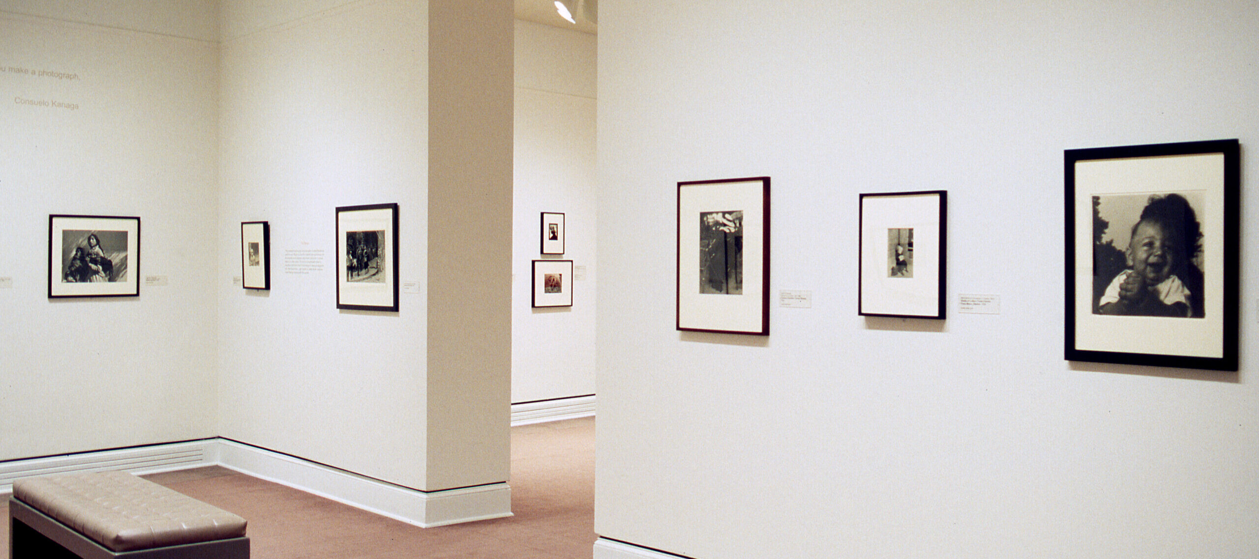 Several black and white photographs hanging on a white gallery wall.