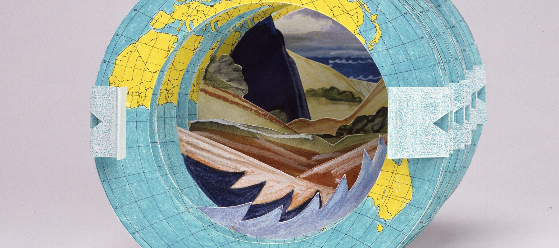 Multiple green and yellow paper globes are stacked on one another with a circular hole in the middle. Through the hole oceans, mountains, and trees are visible.