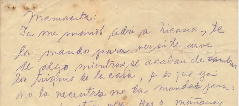 A handwritten letter by Frida Kahlo in Spanish on a piece of tan colored paper that is torn in half.