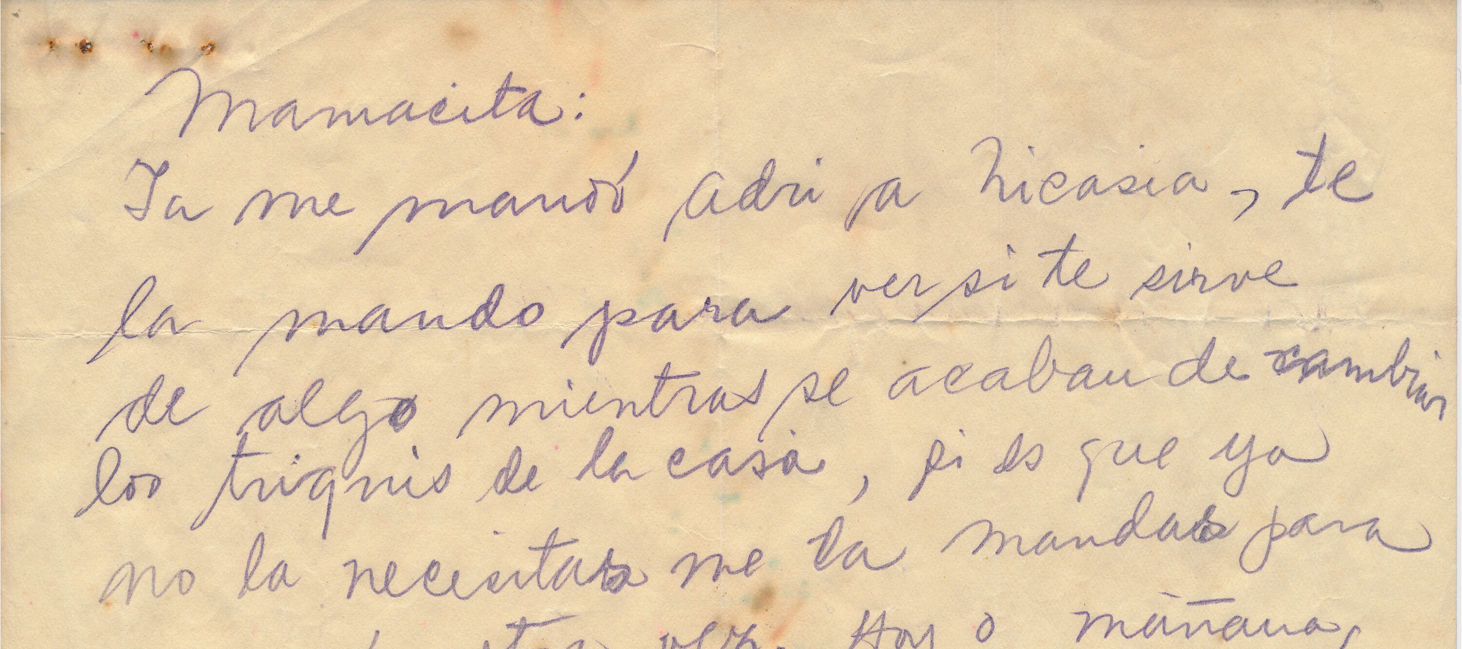 A handwritten letter by Frida Kahlo in Spanish on a piece of tan colored paper that is torn in half.