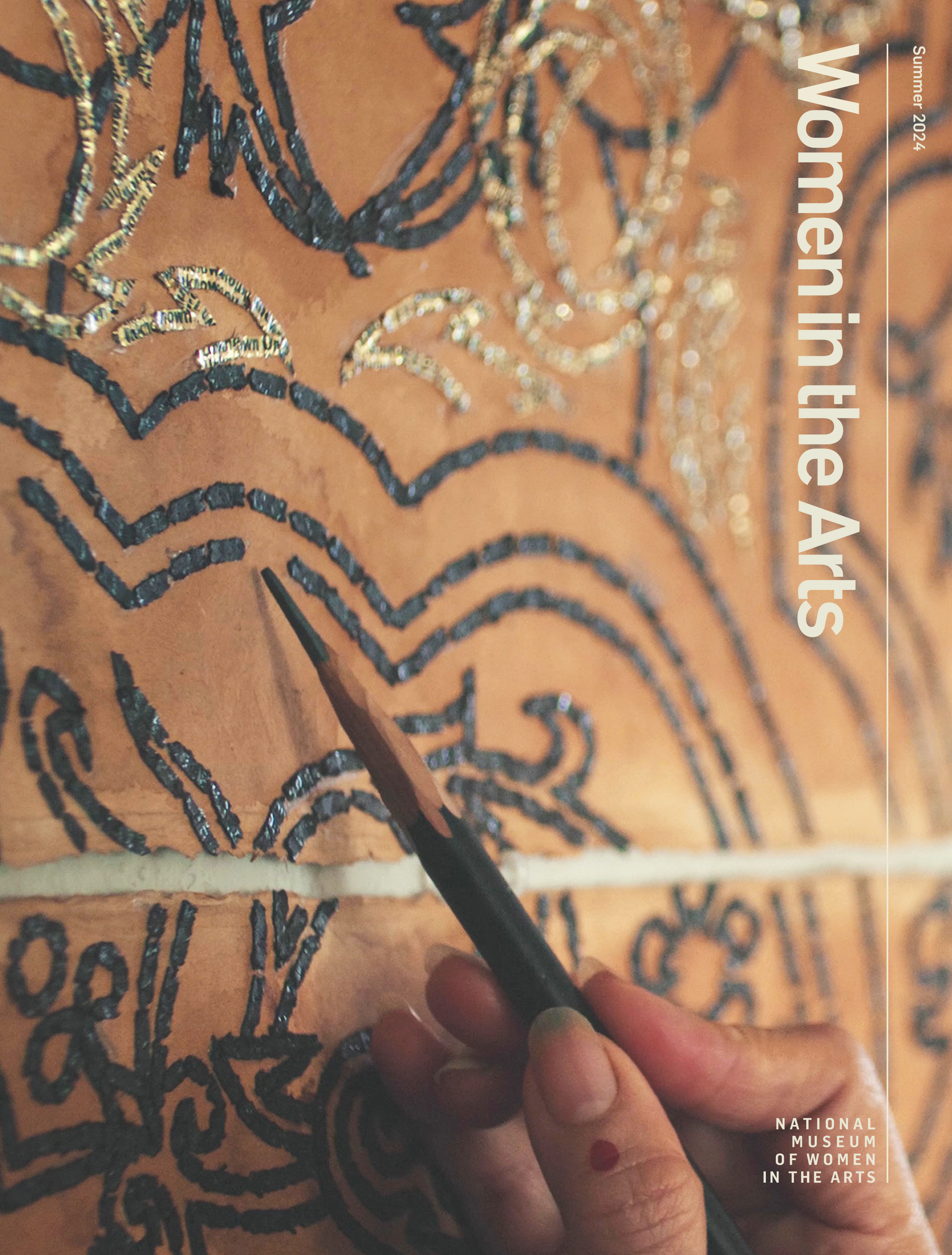 A magazine cover with an image of a hand holding a pencil hovering just above the surface of sepia toned surface with tiny slivers of paper arranged in an organic pattern.
