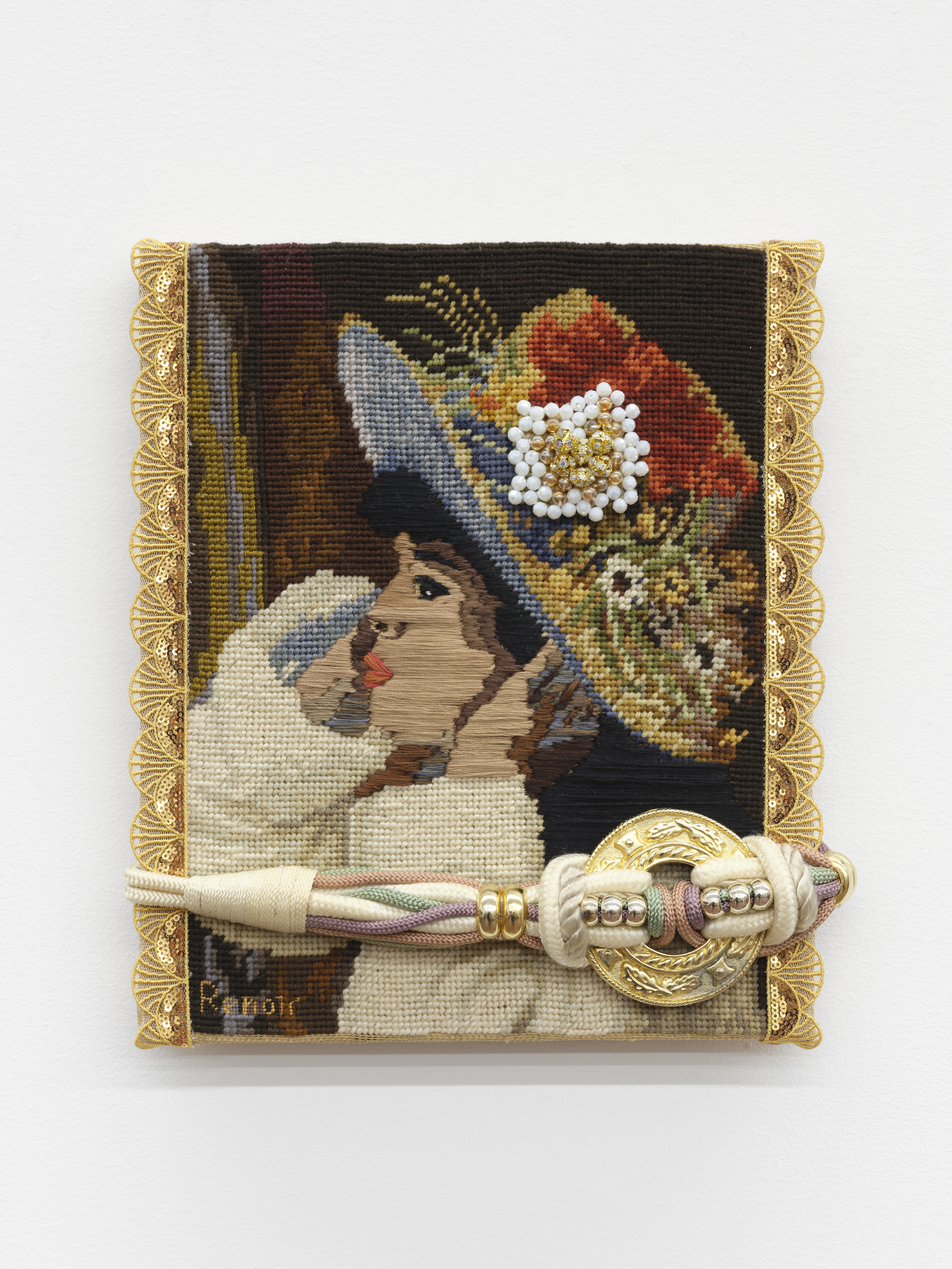 A vintage needlepoint reproduction of a Renoir painting of a girl wearing a brimmed hat covered in flowers. White and gold beads in the shape of a flower are sewn onto the hat. A corded belt with a gold buckle is affixed across the lower part of the needlepoint.