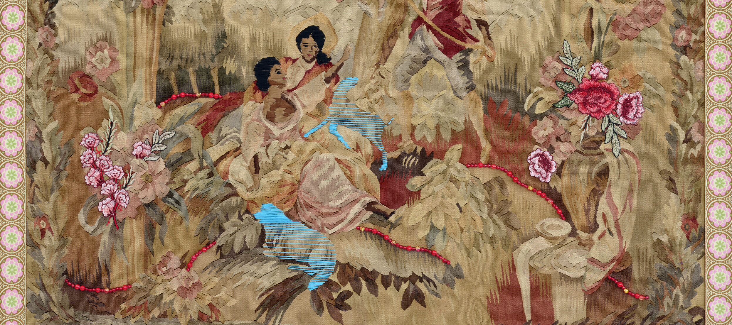 A vintage tapestry depicting three women and one man in a pastoral scene. One woman sits atop a swing while the others sit beneath her. The man holds the rope of the swing. Bright thread and beads are sewn over the original tapestry, and all four figures skin and hair have been darkened with brown and black thread.