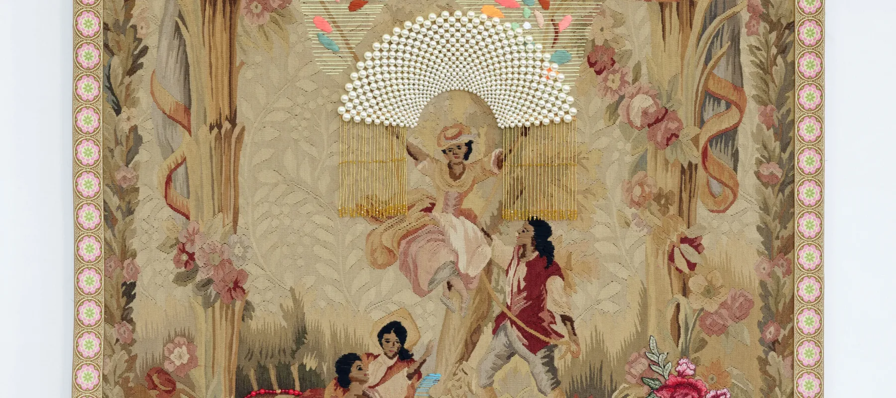 A vintage tapestry depicting three women and one man in a pastoral scene. One woman sits atop a swing while the others sit beneath her. The man holds the rope of the swing. Bright thread and beads are sewn over the original tapestry, and all four figures skin and hair have been darkened with brown and black thread.