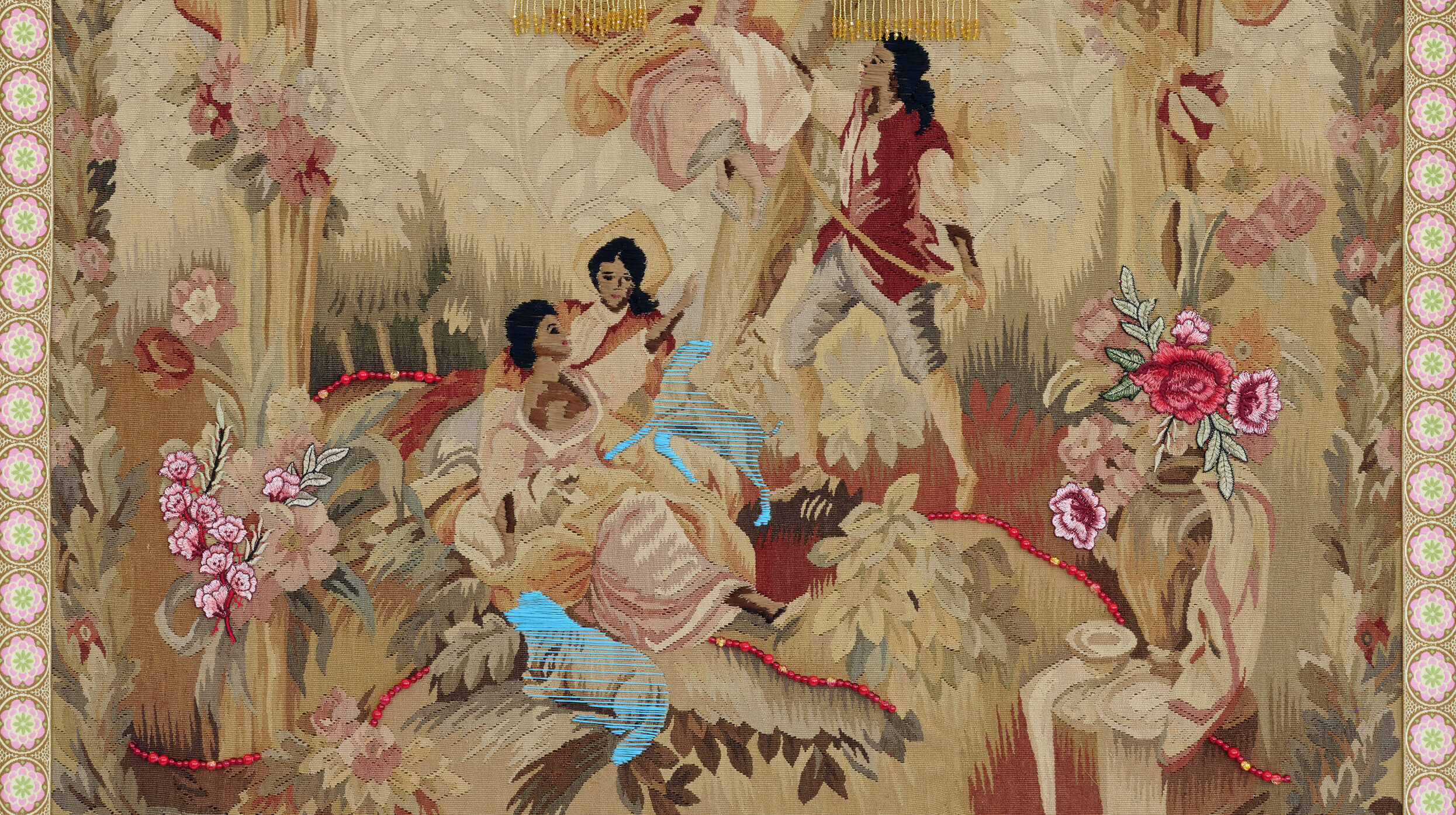 A vintage tapestry depicting three women and one man in a pastoral scene. One woman sits atop a swing while the others sit beneath her. The man holds the rope of the swing. Bright thread and beads are sewn over the original tapestry, and all four figures skin and hair have been darkened with brown and black thread.