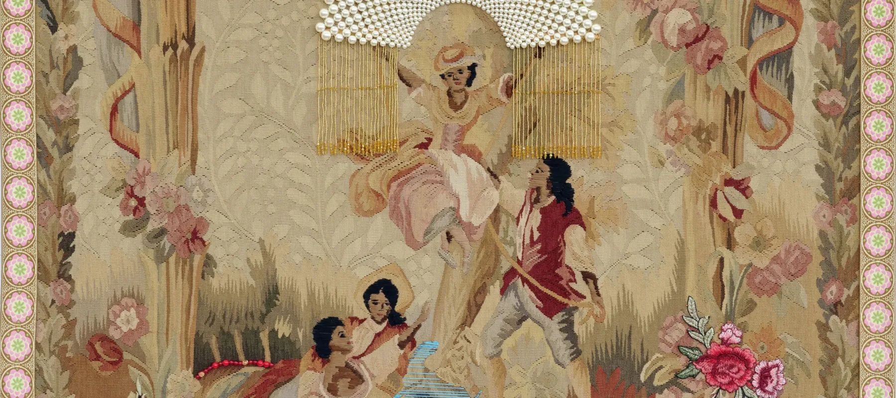 A vintage tapestry depicting three women and one man in a pastoral scene. One woman sits atop a swing while the others sit beneath her. The man holds the rope of the swing. Bright thread and beads are sewn over the original tapestry, and all four figures skin and hair have been darkened with brown and black thread.