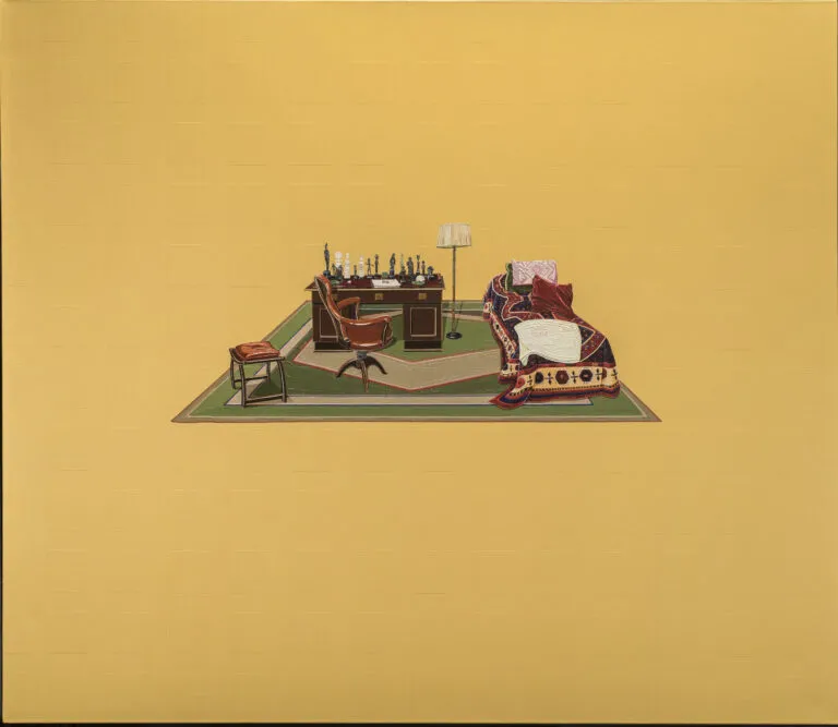 In the middle of a mustard yellow canvas is a small painting of a wooden desk and brown chair. On the desk are various small figurines. A floor lamp and small bed are to the right. The bed is covered with pillows and an ornately designed comforter.