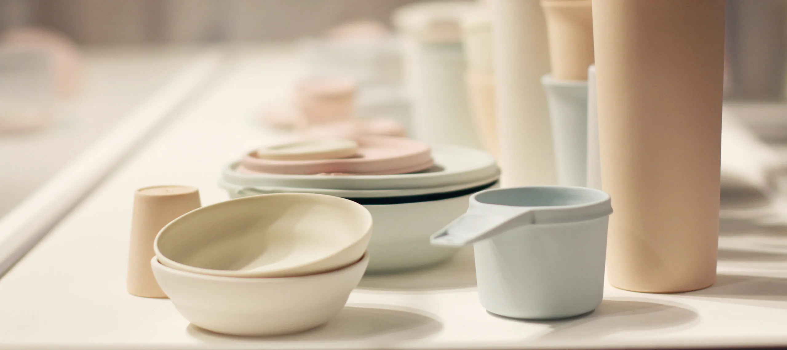 A large collection of pastel, ceramic vessels resembling stacks of myriad Tupperware.