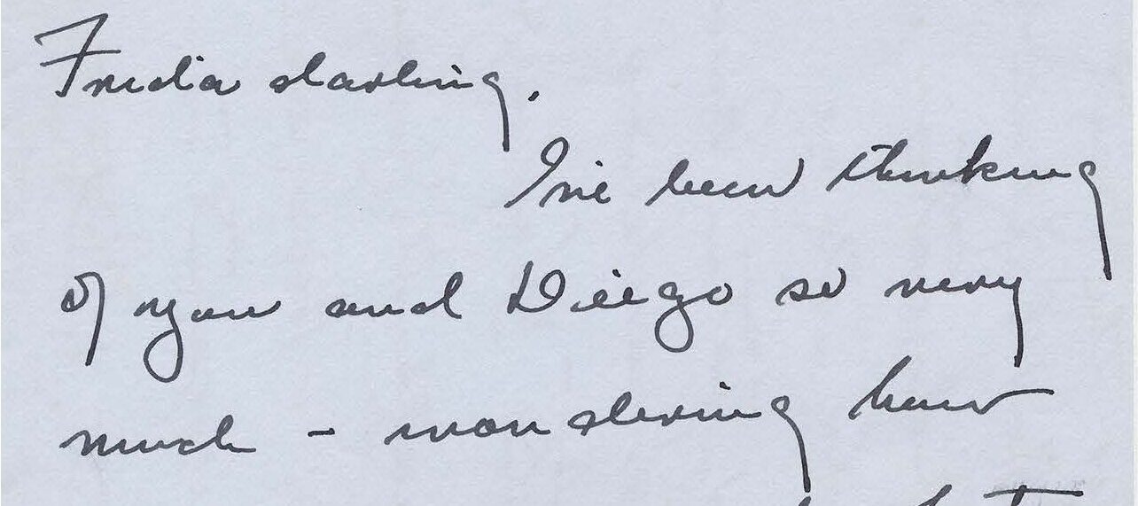 Handwritten letter on gray paper.