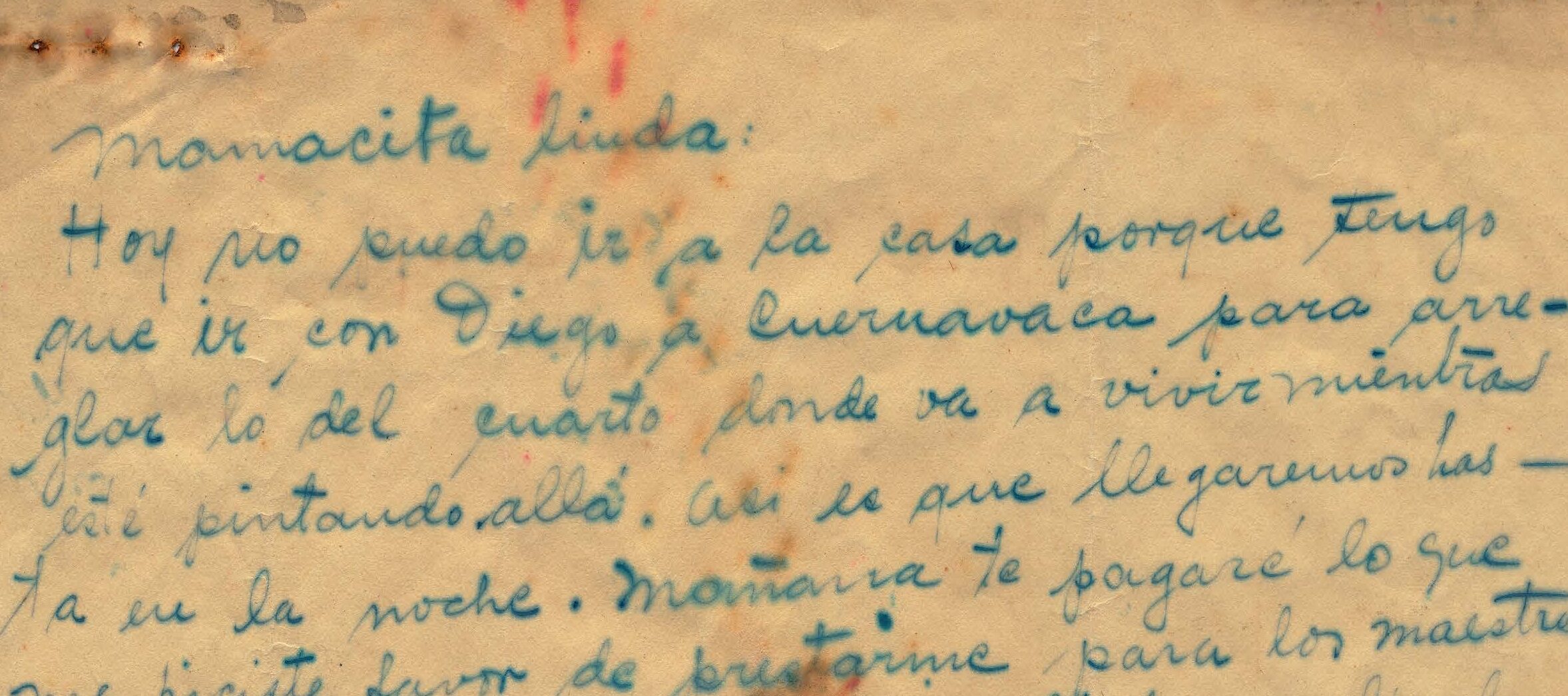 Handwritten letter on yellowed paper with some dark brown and red staining.
