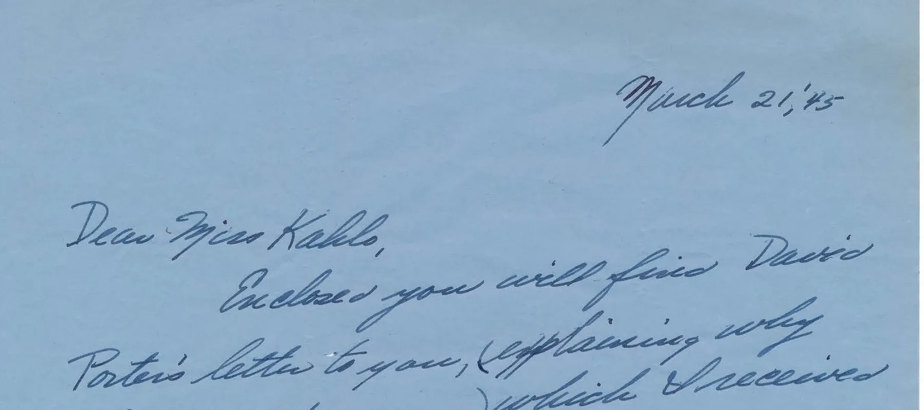 Handwritten letter on blue paper.