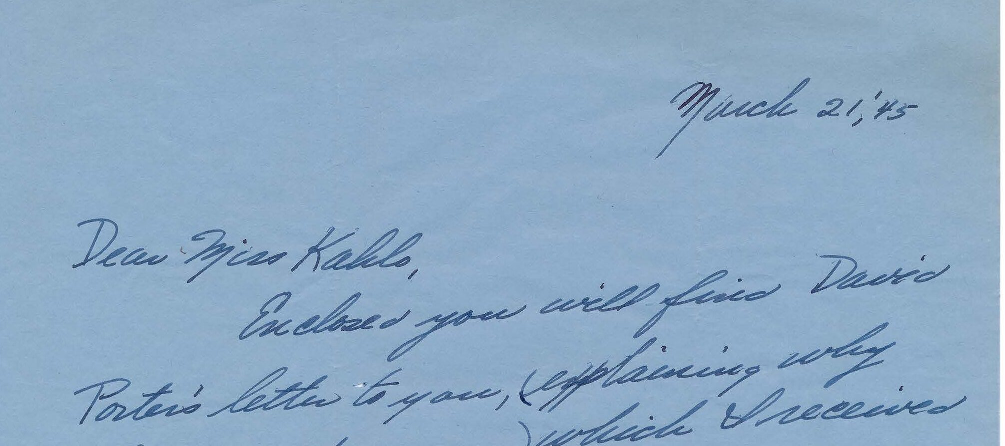 Handwritten letter on blue paper.