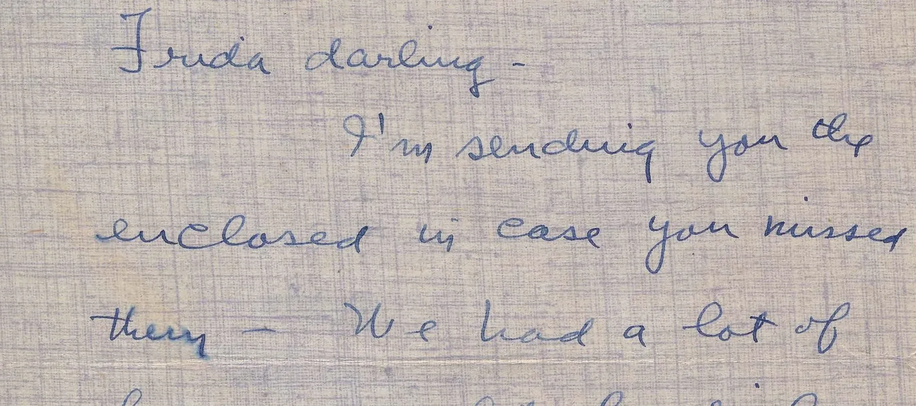 Handwritten letter on blue, textured stationery paper.