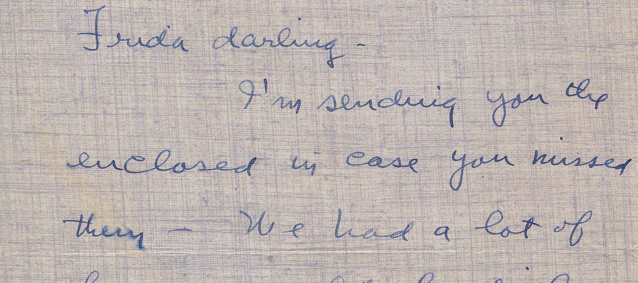 Handwritten letter on blue, textured stationery paper.