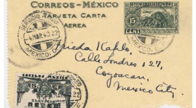 Handwritten envelope on yellowed paper with the image of a palace, stamps, and an address.