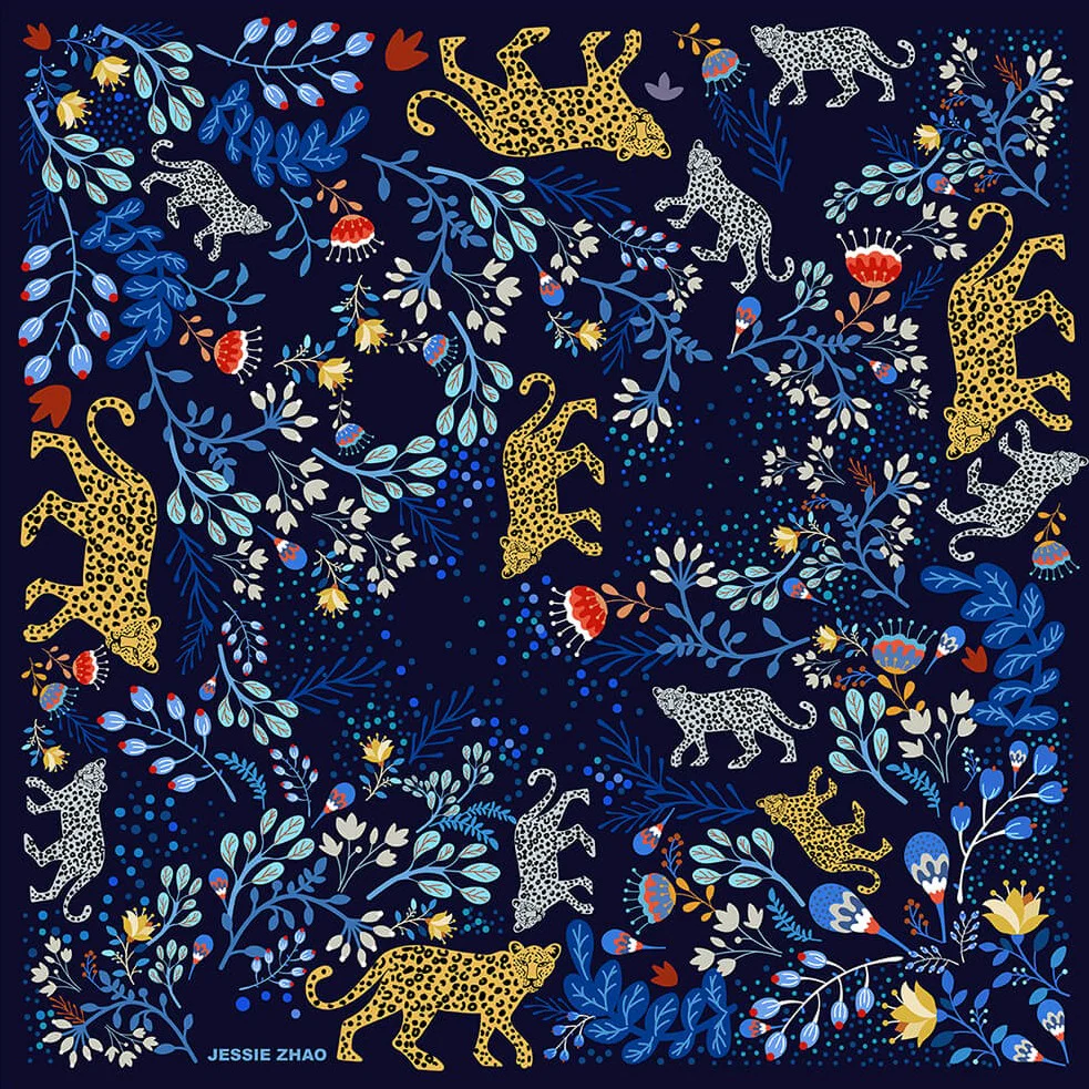 A colorful patterned scarf features a pattern of jungle flora and fauna, including small and large cheetahs, red blooms, and many other mixed flowers.