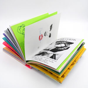 A book with colorful pages lays open.