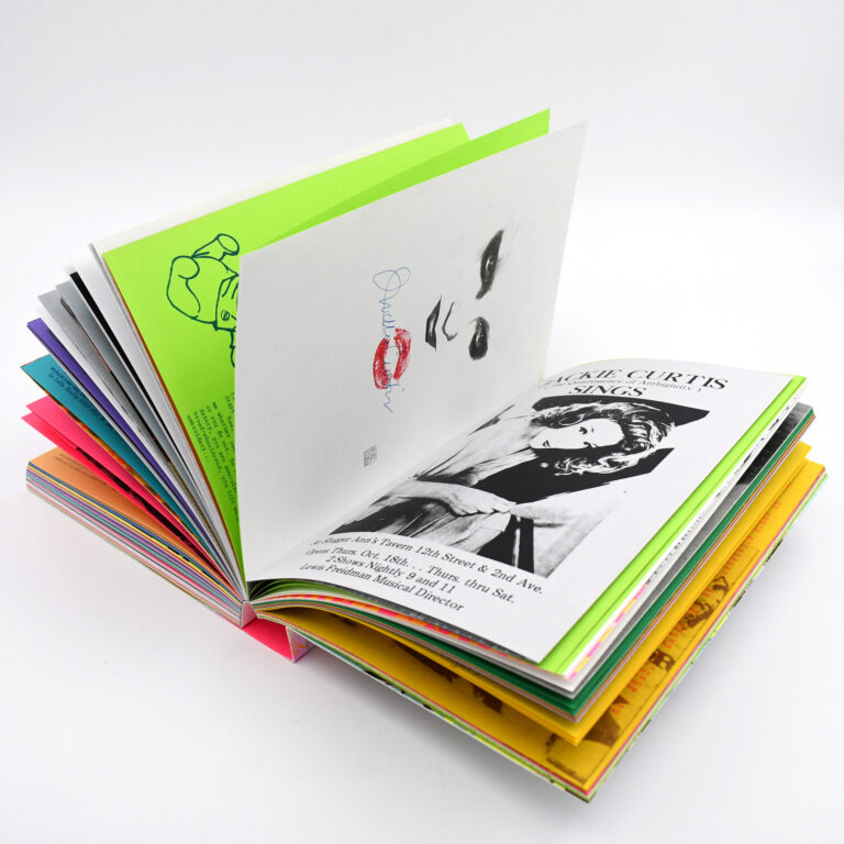 A book with colorful pages lays open.