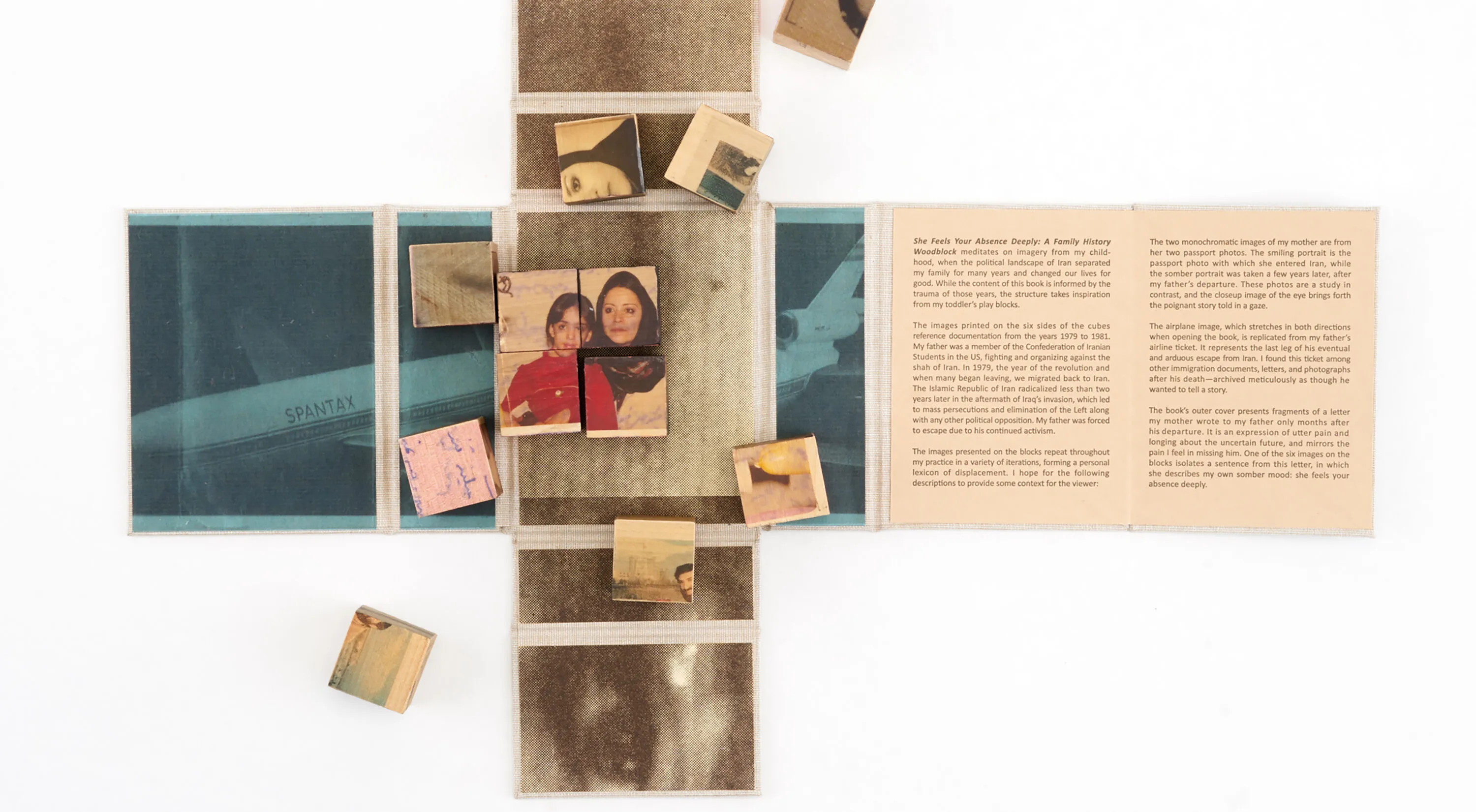 Wooden blocks with vintage photos and text are arranged on an unfolded book or map. Some blocks form a partially completed puzzle. The surrounding surface contains faded images and text panels.