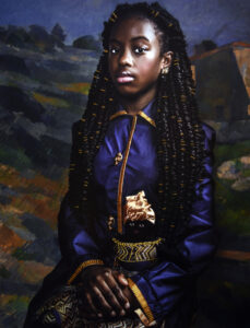 A photograph of a young Black girl. She is seated and wearing a blue dress with gold accents. She holds in her lap a doll, which is dressed in a gold dress and headwrap. The background is a landscape painting by Cezanne.
