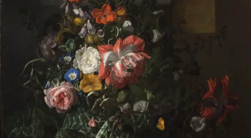A still life painting featuring an asymmetrical arrangement of flowers; the central section features pink, orange, yellow, and blue flowers and is dramatically highlighted compared to the background and outer edge of arrangement.
