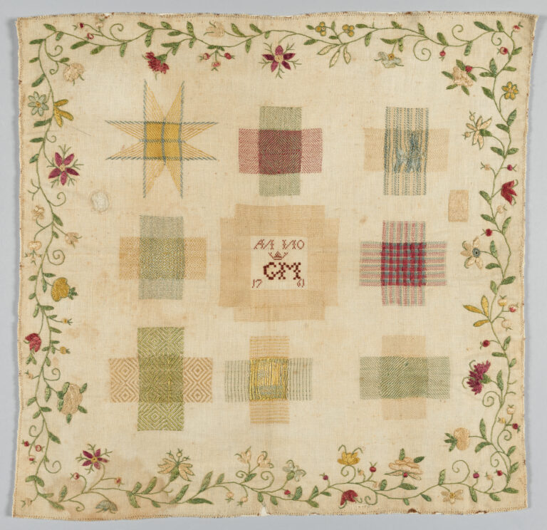 Framed rectangular embroidered darning sampler showing densely worked silk thread stitches in decorative patterns on a linen ground, including geometric motifs and floral-inspired designs in a balanced symmetrical layout.
