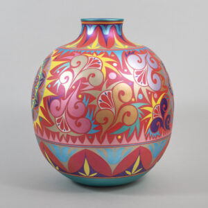 A round ceramic vase with a short neck decorated with intricate geometric and floral patterns painted in red, pink, blue, yellow, and purple.