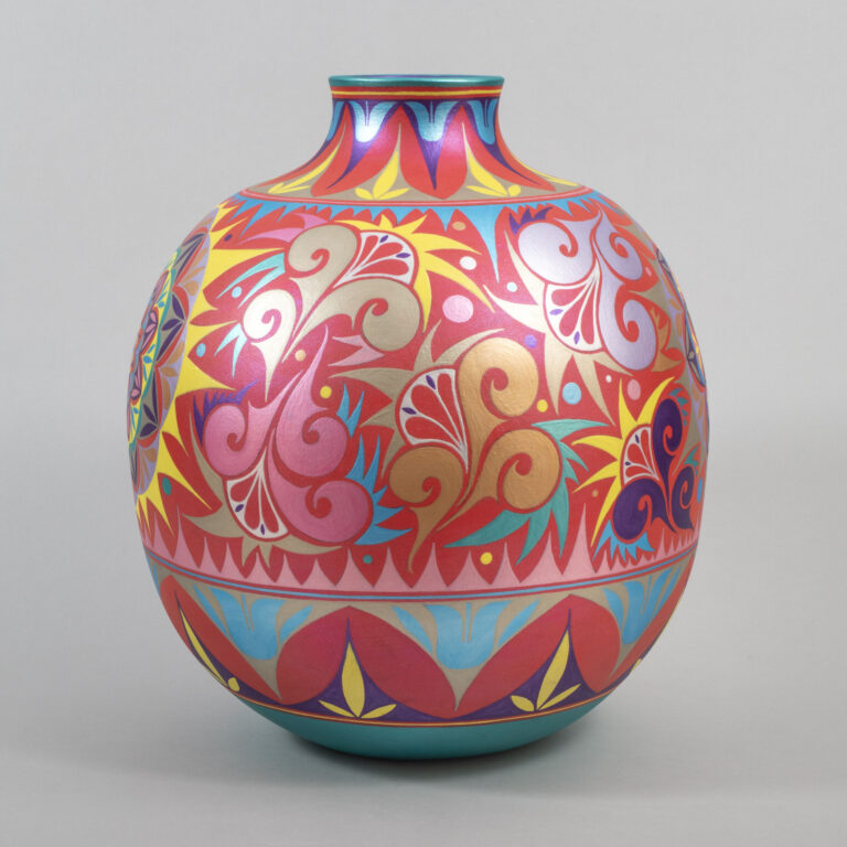 A round ceramic vase with a short neck decorated with intricate geometric and floral patterns painted in red, pink, blue, yellow, and purple.
