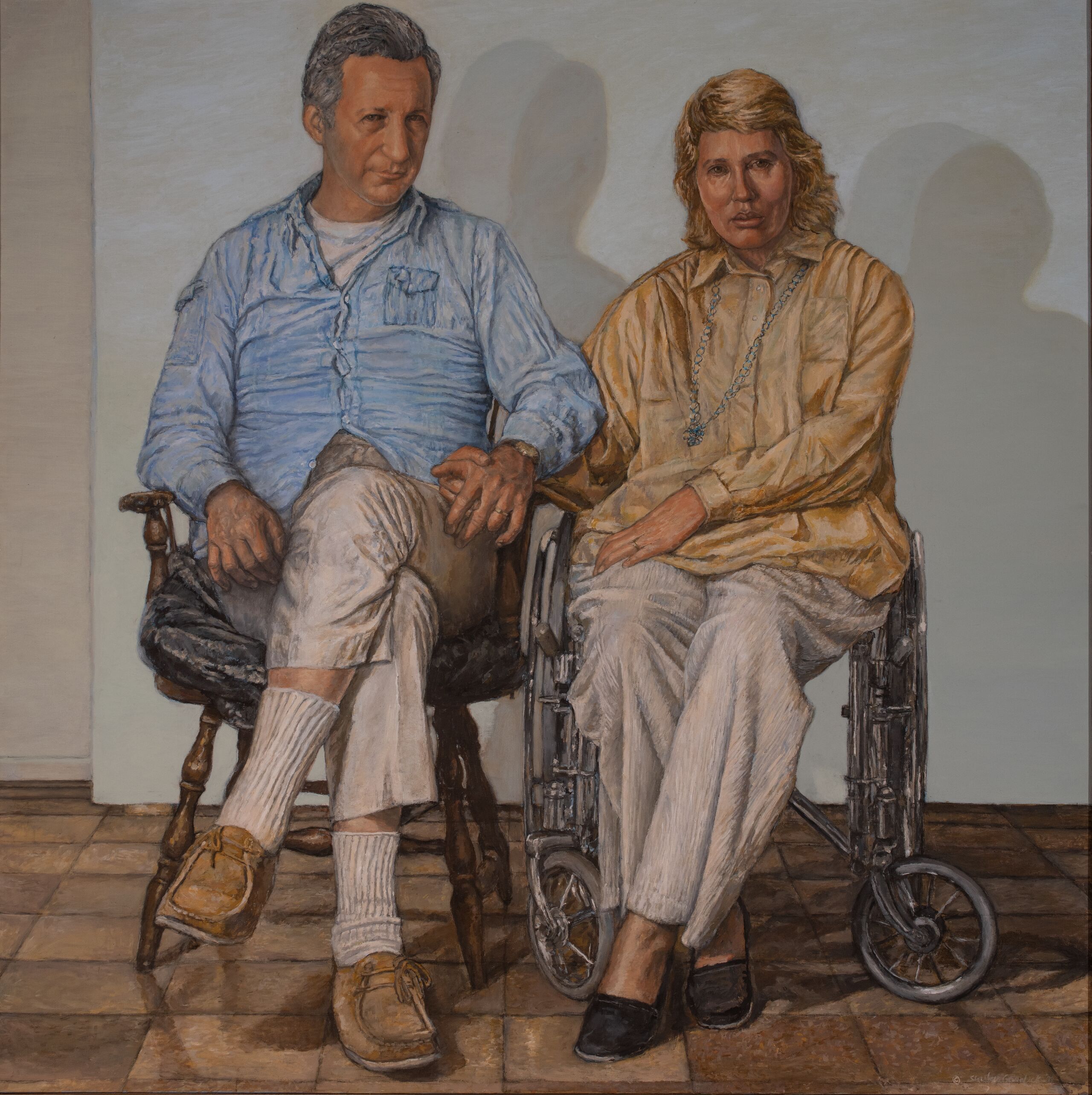 In a painted portrait, a mature man and woman with light skin tone are seated closely together, the man in a wooden chair and the woman in a wheelchair. They face outward toward the viewer and hold hands; they are shown in a sparse, neutral-painted room with a brown tile floor.