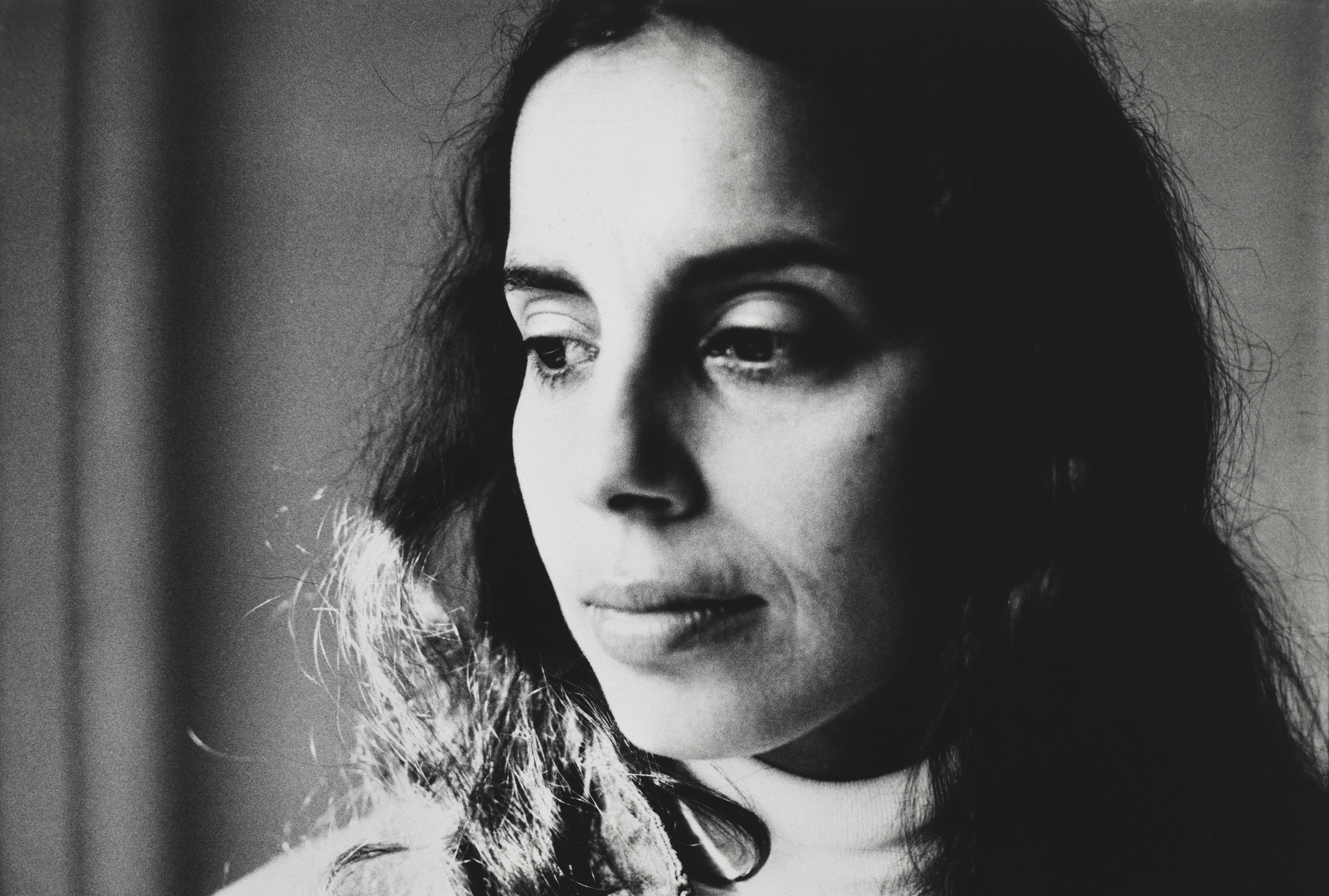 A black and white photograph of a woman with dark hair.