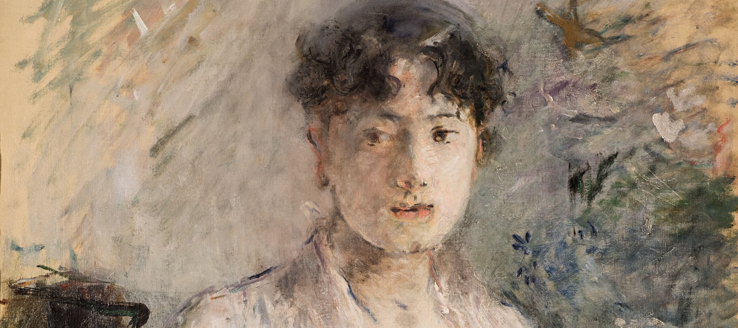 An Impressionist painting of a light-skinned adult woman sitting in a chair and holding something in her lap, seen from the waist up. She has short, curly, dark bangs and she wears a white dress. The painting is rendered in thick, loose brushstrokes, so it appears blurry.