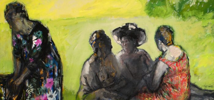Four people are depicted outdoors on green grass; three are seated and talking, two in hats, while one person in a floral dress stands to the left, partially turned away. The scene is painted in vibrant, impressionistic colors.