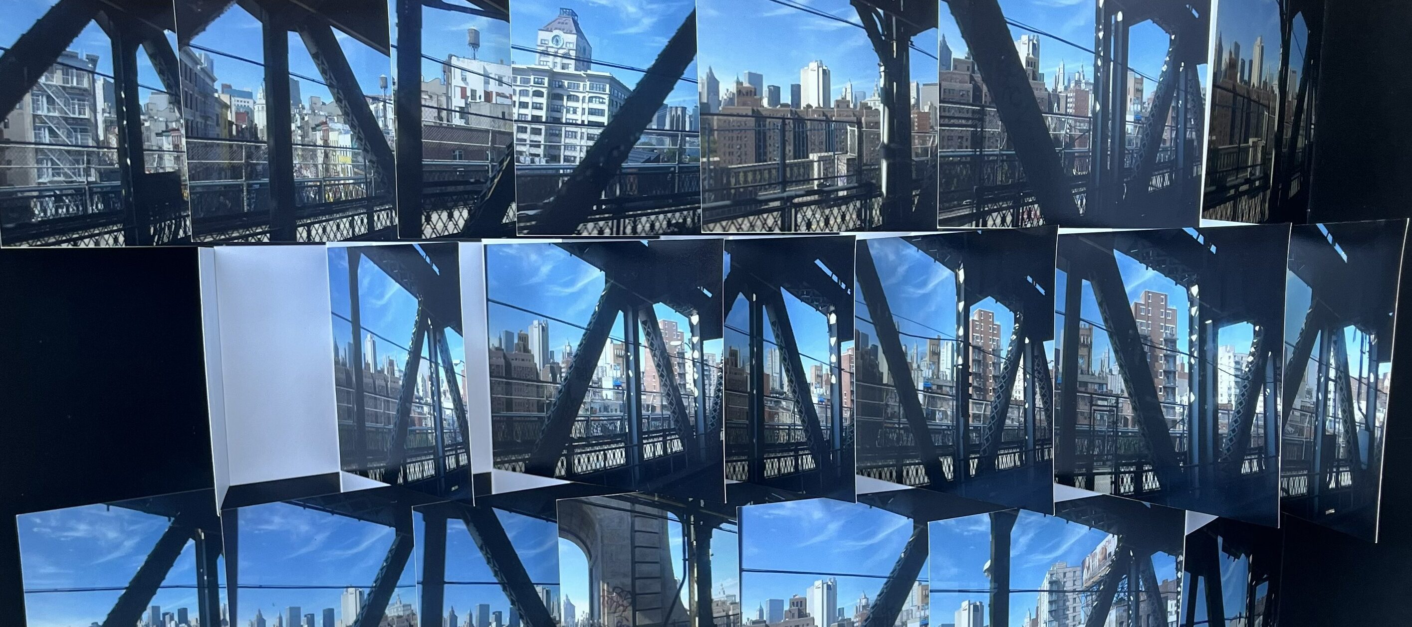 Artist's book featuring multiple images of an urban skyline arranged in a 3D accordion style, creating depth. Bright blue sky and metal beams are visible.
