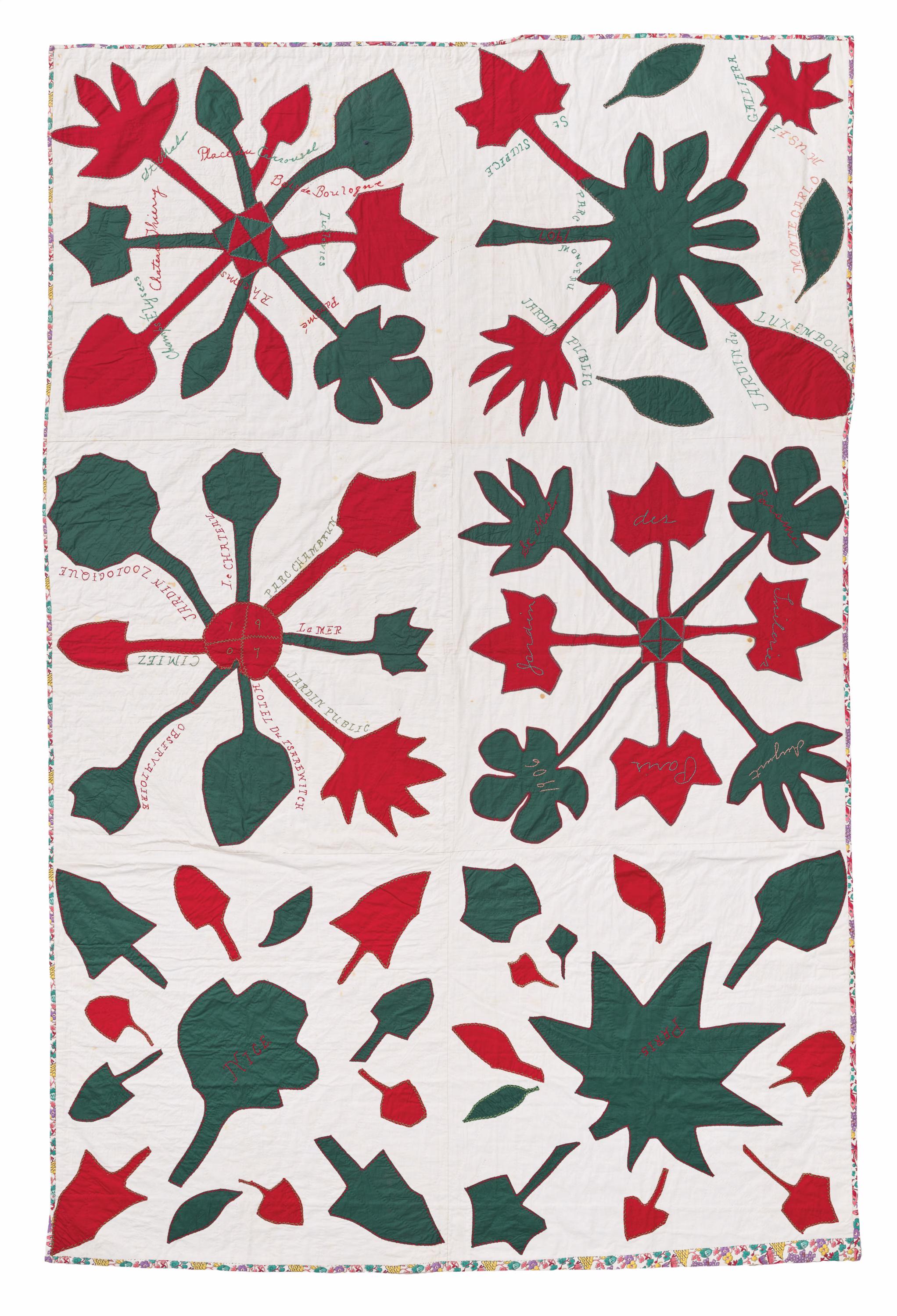 Over an off-white fabric quilt, red and deep-green elements appear in different leaf shapes. The leaf clusters are punctuated by lightly embroidered text.